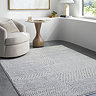 image of black and ivory geometric rug on light grey floor of modern apartment