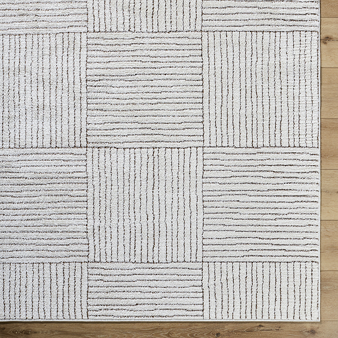 close up image of corner of ivory and brown alternating striped rug