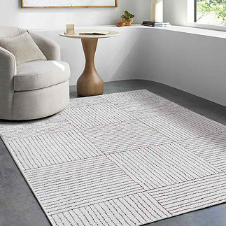 image of ivory and brown striped rug on grey flooring of modern apartment