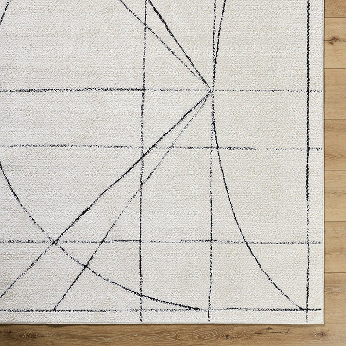close up image of ivory rug with modern black blueprint pattern