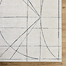 close up image of ivory rug with modern black blueprint pattern