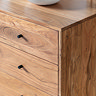 close up on smooth corner of acacia wood sideboard with iron handles