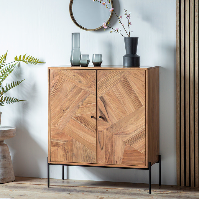 image of two door acacia wood drinks cabinet against a wall with decorative accessories atop it
