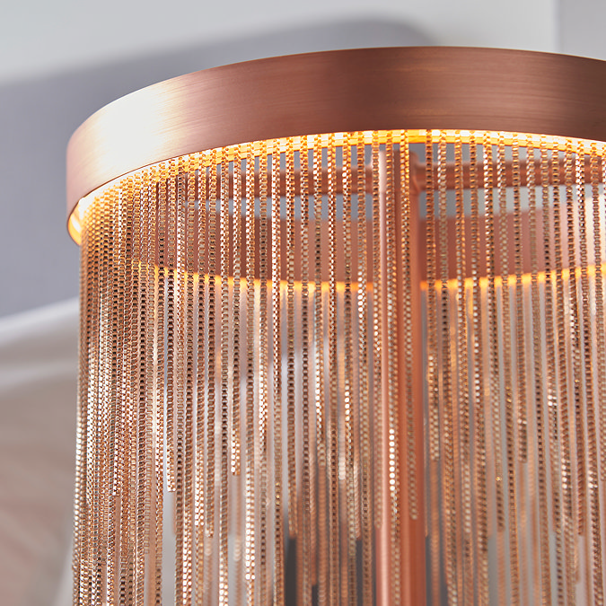 close up on fringed tassels of brushed copper table lamp