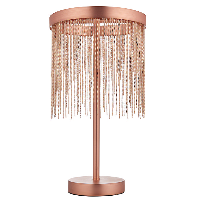 image cut out on white background of brushed copper tasselled table lamp