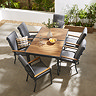 image taken from above of slatted teak finish dining table, extendable function contracted, with six chairs around it