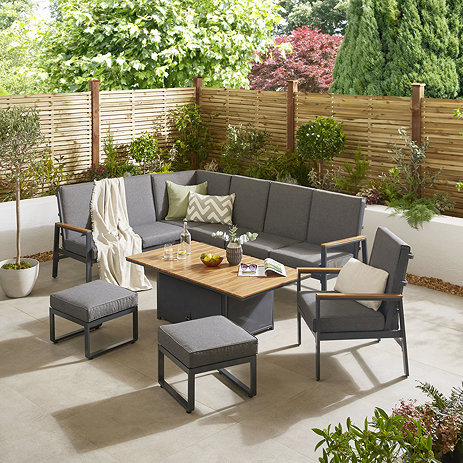 image of grey corner lounge set with teak arms, matching chair and two stools, around a rectangular coffee table with lifting slatted tabletop