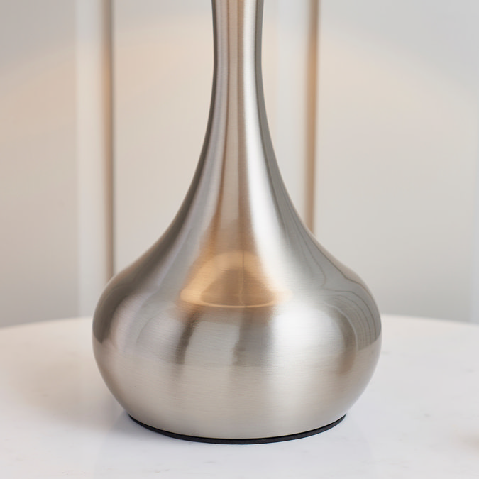 close up image of base of slim nickel table lamp