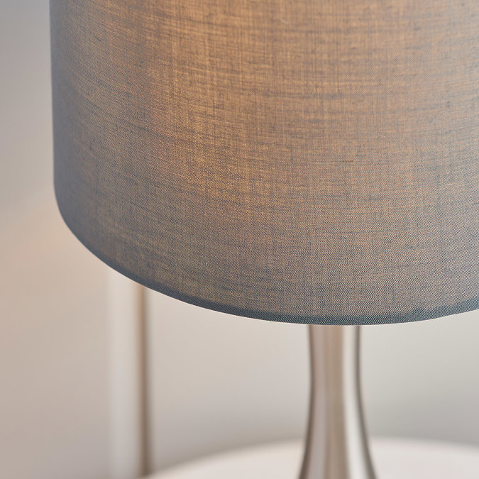 close up image of linen shade of nickel and grey table lamp
