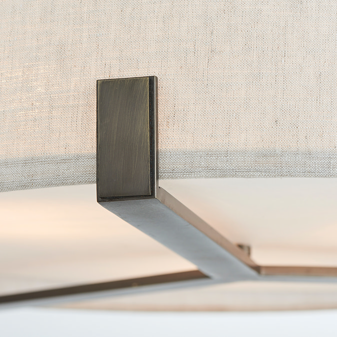 close up on bronze-effect framework of pendant light where shade rests upon it