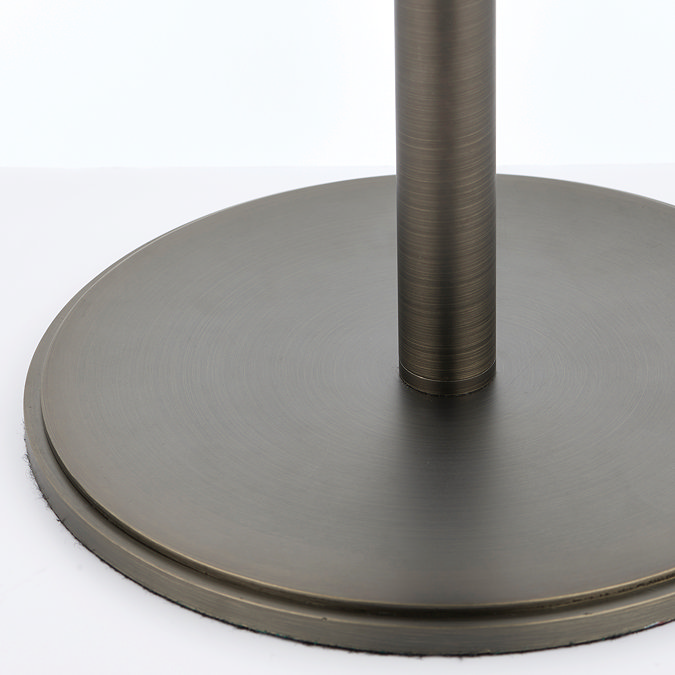 close up image of bronze metalwork of circular base of table lamp