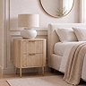 lifestyle image of two drawer oak fluted bedside table