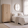 lifestyle image of fluted oak wardrobe next to bed with gold mirror above it