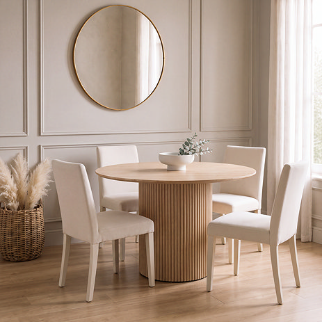 lifestyle image of oak fluted round dining table, with modern white chairs around it