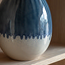 close up image on faded drip effect lower half of ceramic glazed vase