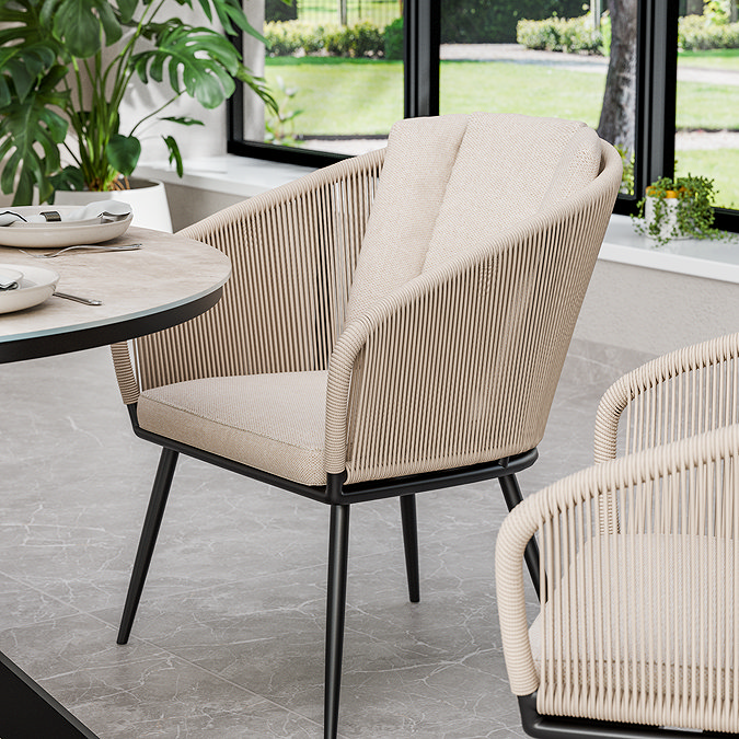 close up image of cream dining chair with black metal legs as part of garden set