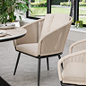 close up image of cream dining chair with black metal legs as part of garden set