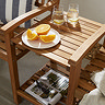 close up image of middle bench section of wooden companion bench/love seat, with orange slices and glasses of water on top of it