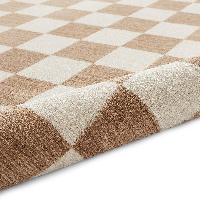 image of beige checkered rug rolled up at the end