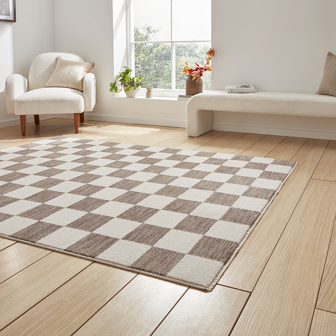 angled image of grey checkered rug on light wooden flooring