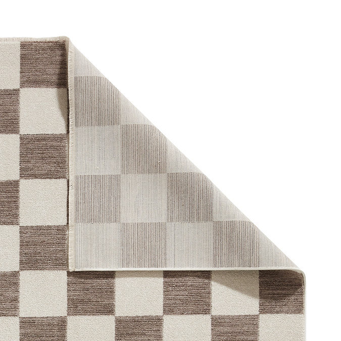 image of checkered grey and cream rug with corner folded over to show floor-facing material