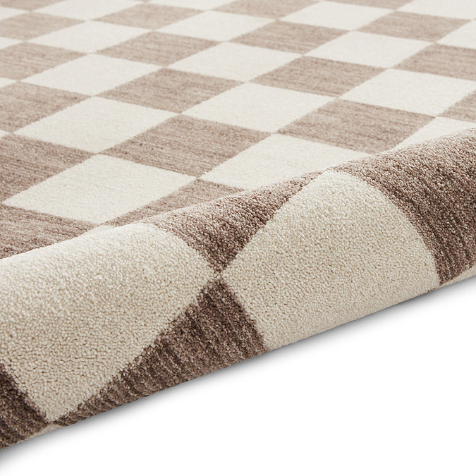 image of grey and cream rug rolled up at the end