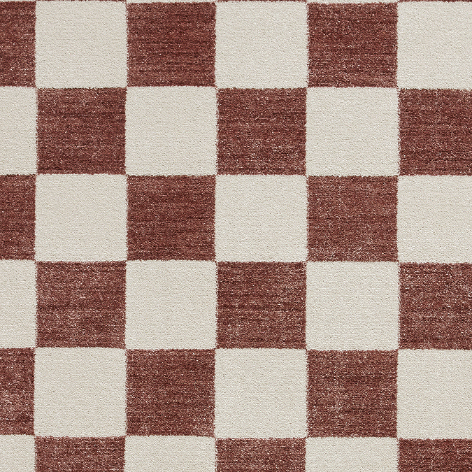close up on texture and colour of plum and cream checkered rug
