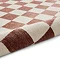 image of plum and cream rug rolled up at the end
