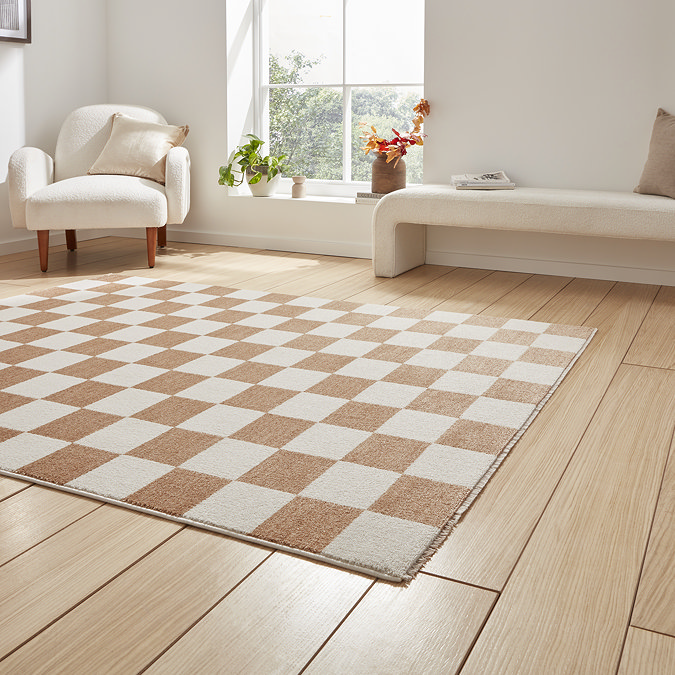 angled image of light brown and cream checkerboard rug on light wooden floor of modern loft apartment