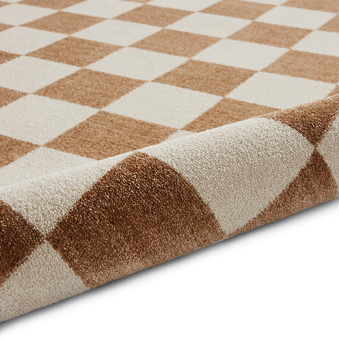 image of cream and walnut brown checkered rug rolled up at the end