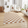 image of walnut brown and cream checkerboard rug on light wooden flooring of modern loft apartment
