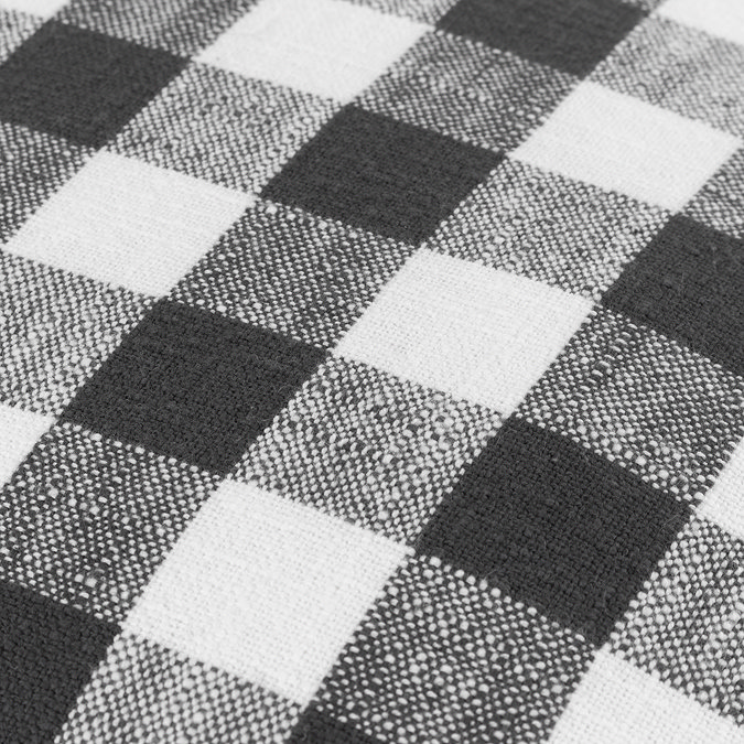 close up image of checkered black and white patterned cushion