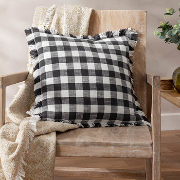 close up image of checkered black and white patterned cushion