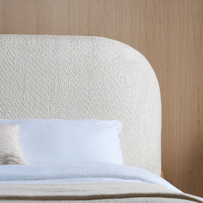 close up image on white boucle headboard of bed