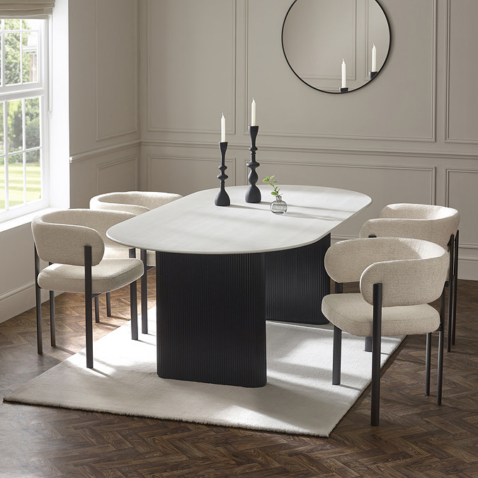 image of four cream chenille dining chairs round cream and black matching dining table