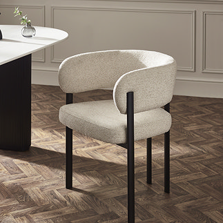 image of cream chenille dining chair with modern black legs on dark wooden flooring, next to matching table with cream top