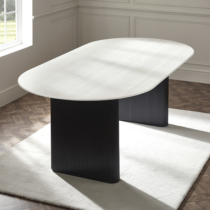 image of oval marble effect dining table with black fluted pedestal legs, without dining chairs