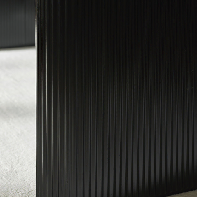 close up image of fluted black legs of dining table