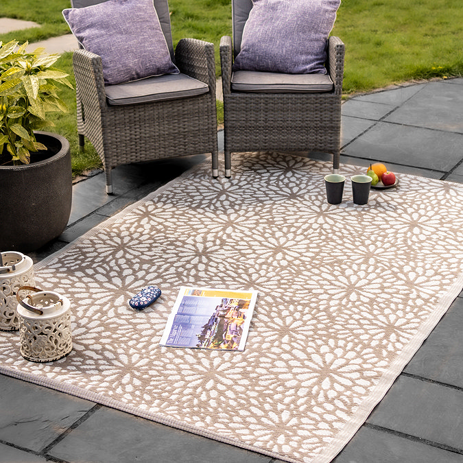 image of mocha brown-yellow floral rug on grey stone patio