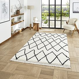 white and black boho rug on floor image 1