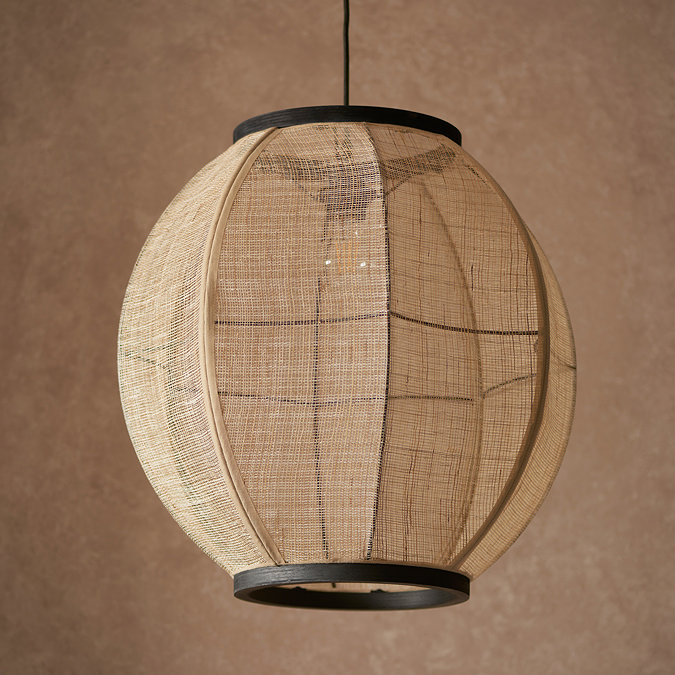 close up image of circular boho style light shad, see through linen with black edges and cable
