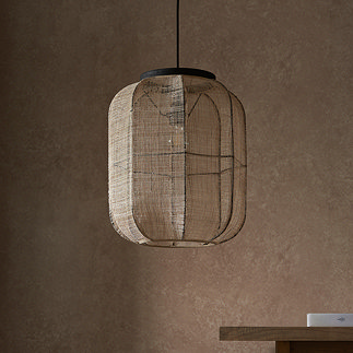 image of rectangular linen pendant light with black trim, in front of warm brown wall