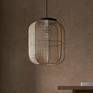 close up image of rectangular linen pendant light with black fixture in front of warm brown wall