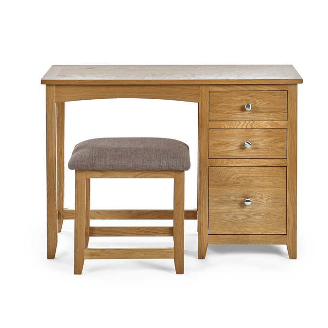 image cut out on white background of solid oak single dressing table with coordinating stool, three drawers on the right hand side