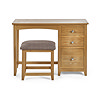 image cut out on white background of solid oak single dressing table with coordinating stool, three drawers on the right hand side