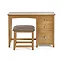 image cut out on white background of solid oak single dressing table with coordinating stool, three drawers on the right hand side