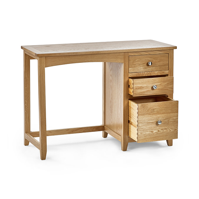 image cut out on white background of solid oak single dressing table with three drawers on right hand side, bottom and middle ones pulled out slightly to suggest ample storage space inside