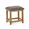 image cut out on white background of oak stool with grey padded top