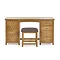 image cut out on white background of solid wood dressing table with six drawers and padded stool pushed underneath