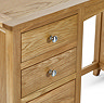 close up on wooden drawers with round metal handles of solid wood dressing table